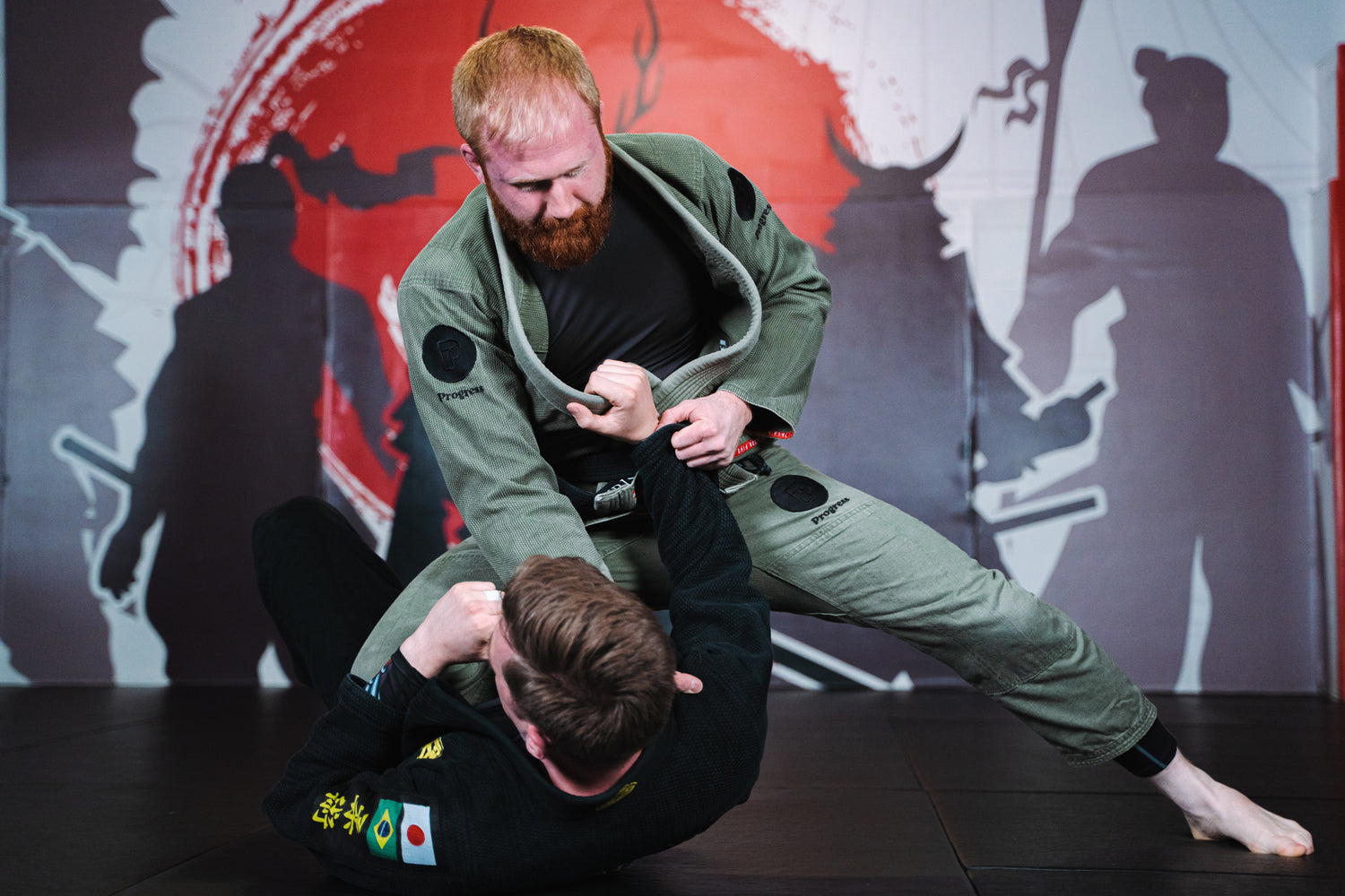 A photo of Evade Martial Arts Brazilian Jiu Jitsu coach Christian Knight demonstrating a BJJ position as part of the Evade Martial Arts Tameside and BJJ Tameside programs